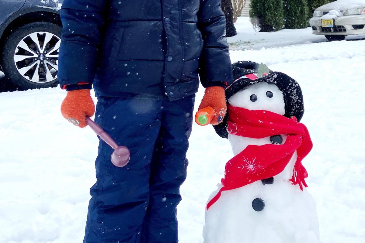 Child with a snowman sculpture